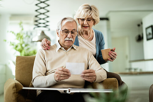 Mature couple looking at their photo album.